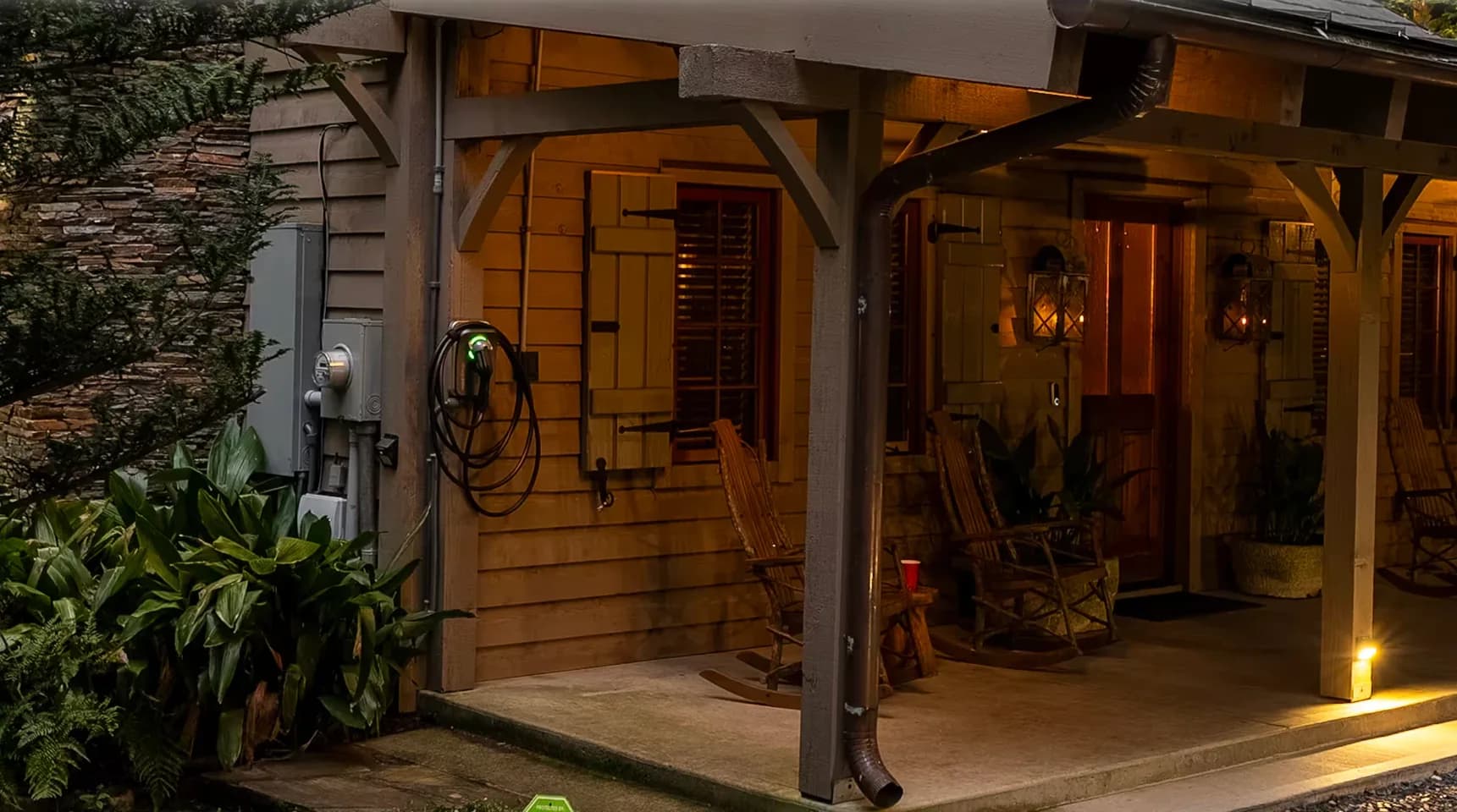Level 2 EV charger mounted on the front porch of a riverfront cabin rental in Marietta SC