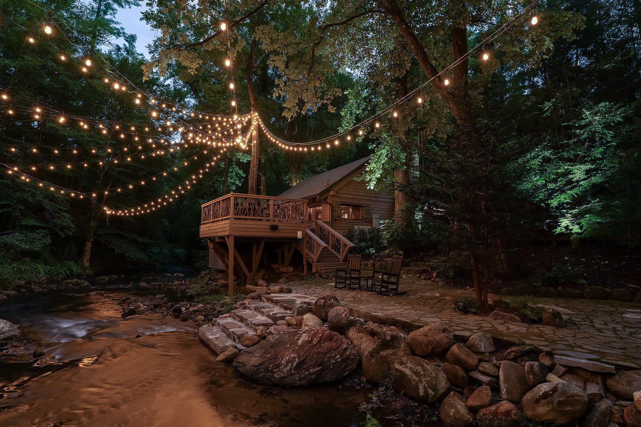 Riverfront cabin deck over the Middle Saluda River in Marietta SC with string lights